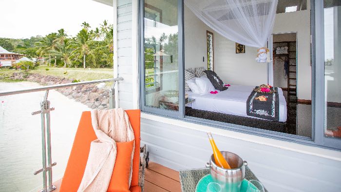 overwater villa with a private deck overlooking crystal-clear turquoise waters
