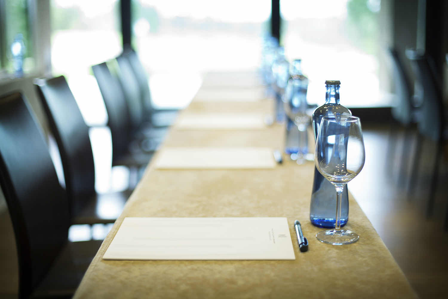 A corporate retreat set outdoors with tables, chairs, and tropical surroundings.